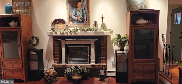 living area featuring baseboard heating and a fireplace