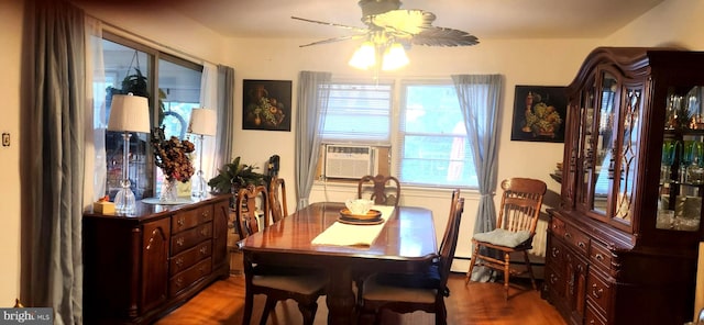 dining area with hardwood / wood-style flooring, ceiling fan, cooling unit, and a baseboard radiator