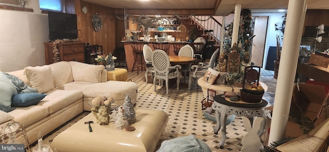 living room featuring carpet flooring and wood walls