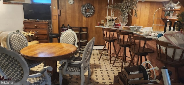 dining space with wooden walls