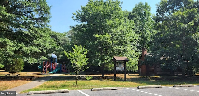 view of vehicle parking featuring a playground