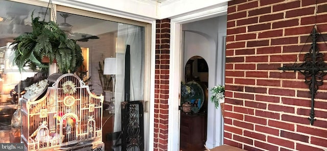 entrance to property featuring brick siding