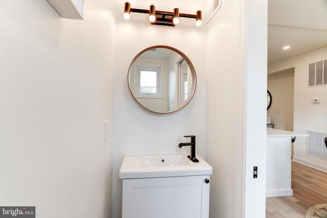 bathroom with hardwood / wood-style floors and vanity