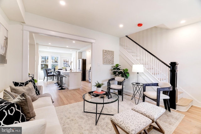 living room featuring light hardwood / wood-style floors and sink