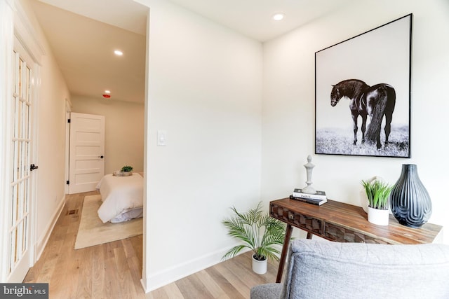 corridor with light hardwood / wood-style flooring