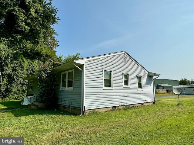 view of home's exterior with crawl space and a lawn