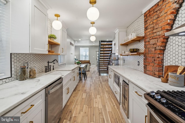 kitchen featuring dishwasher, light stone counters, hanging light fixtures, and tasteful backsplash