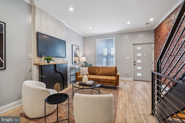 living room featuring crown molding and light hardwood / wood-style flooring