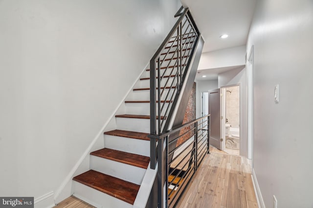 stairs with hardwood / wood-style floors