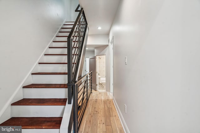 staircase featuring wood-type flooring