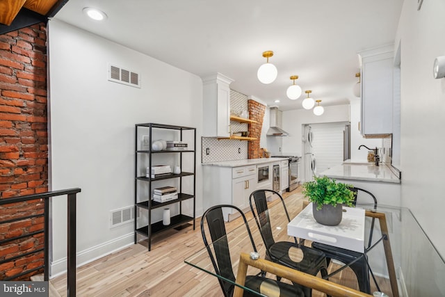 dining area featuring sink and light hardwood / wood-style floors