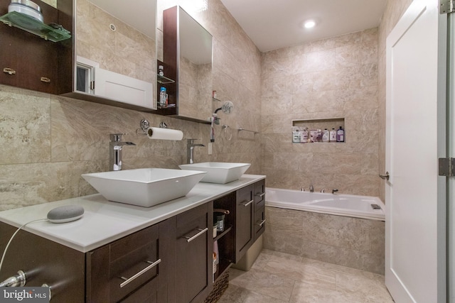 bathroom featuring tile walls, double sink vanity, tile patterned floors, and backsplash