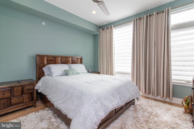 bedroom with ceiling fan and light wood-type flooring