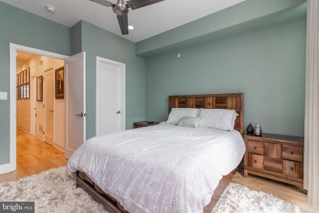 bedroom with light wood-type flooring and ceiling fan