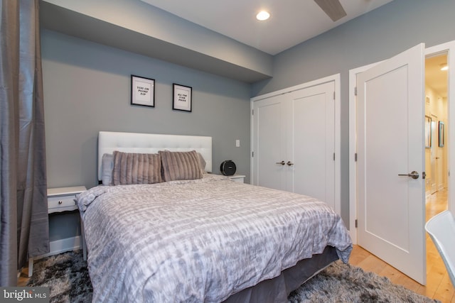 bedroom with ceiling fan and hardwood / wood-style flooring