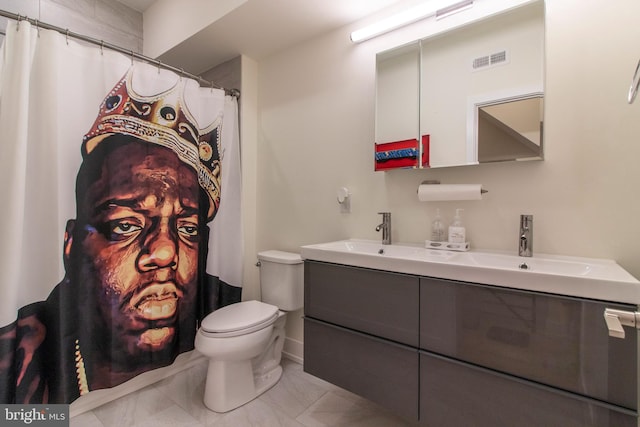 bathroom with tile patterned floors, vanity, and toilet