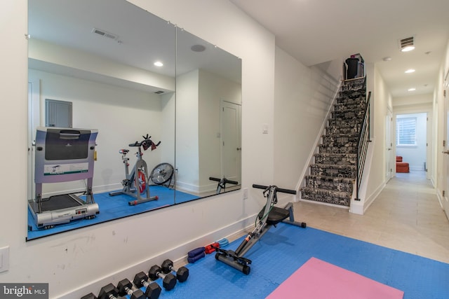 exercise room with light tile patterned floors