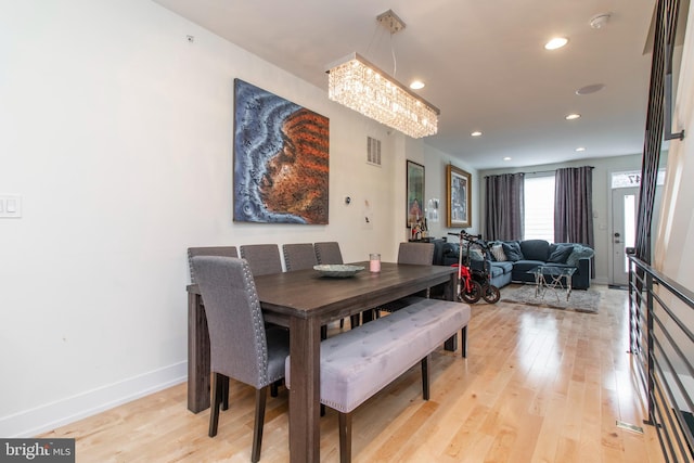 dining space featuring a chandelier and light hardwood / wood-style floors