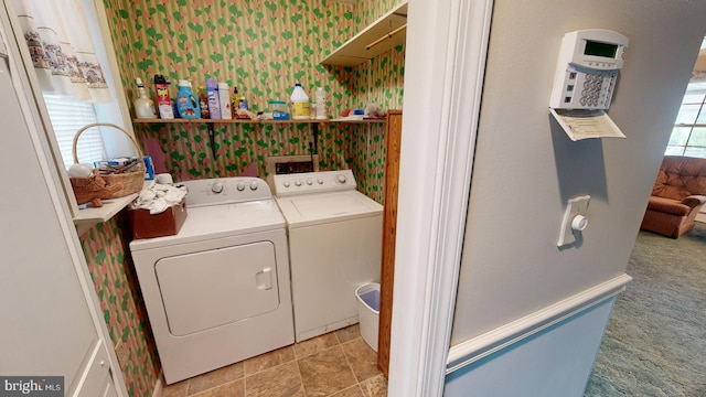 laundry room with washer and clothes dryer and light colored carpet