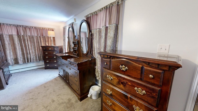 bedroom with light carpet and a baseboard radiator