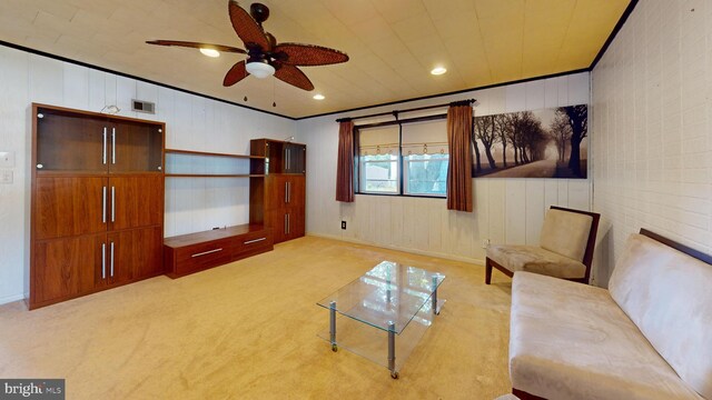 unfurnished living room with ceiling fan, light carpet, and crown molding