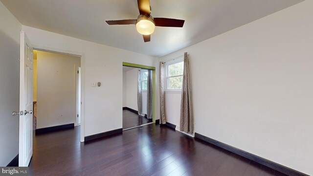 unfurnished bedroom featuring a closet, ceiling fan, and dark hardwood / wood-style floors