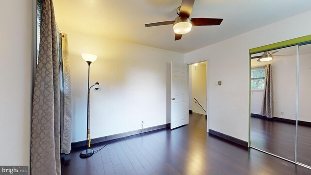 spare room featuring ceiling fan and dark hardwood / wood-style flooring