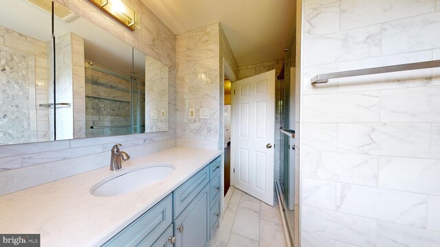 bathroom with tile patterned floors, vanity, and tile walls