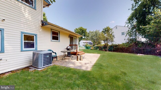 view of yard with cooling unit and a patio