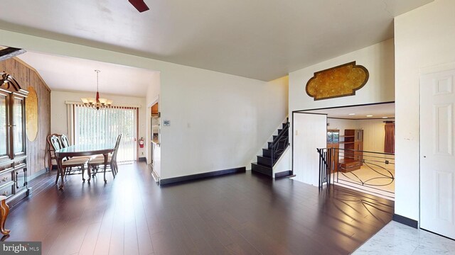 living room with dark hardwood / wood-style flooring and a chandelier