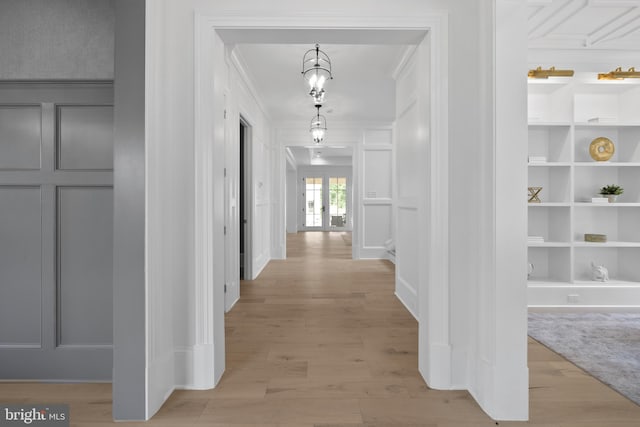 corridor with crown molding and wood-type flooring