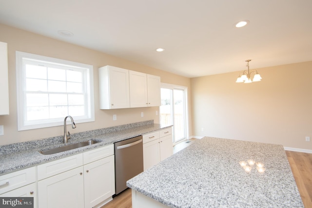 kitchen with dishwasher, white cabinetry, a wealth of natural light, and sink