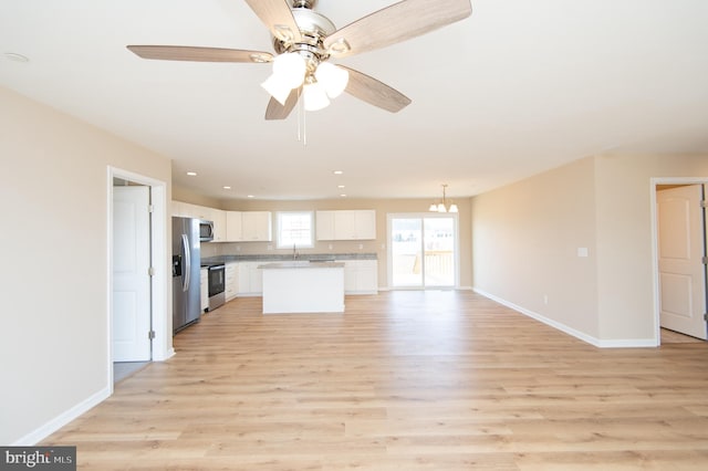 kitchen featuring a center island, white cabinetry, and light hardwood / wood-style flooring