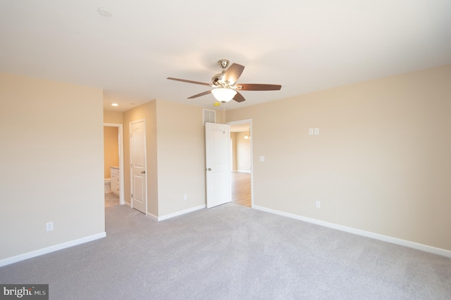 carpeted empty room featuring ceiling fan