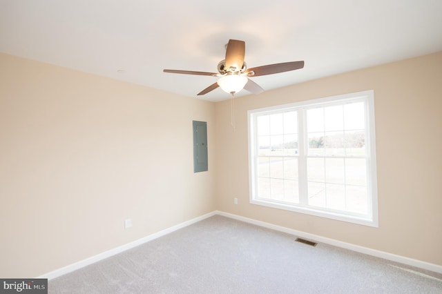 carpeted spare room featuring electric panel and ceiling fan