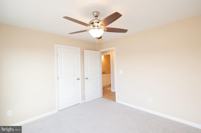 unfurnished bedroom with ceiling fan and light carpet