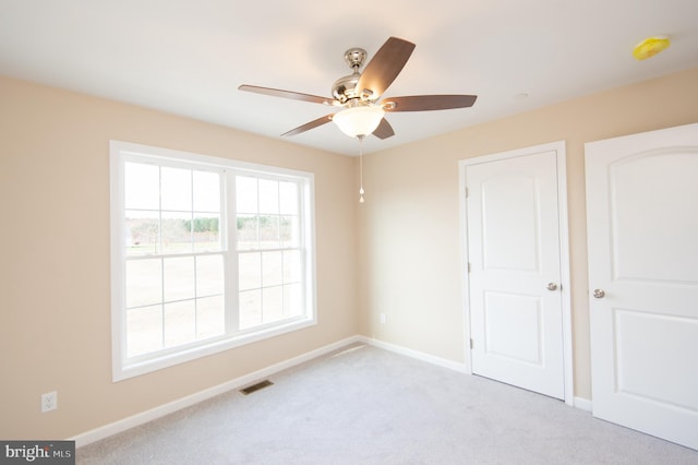 unfurnished bedroom with ceiling fan and light carpet