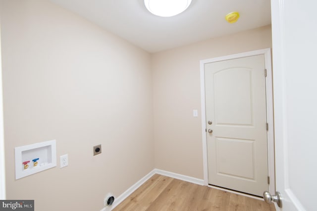 clothes washing area featuring electric dryer hookup, light hardwood / wood-style flooring, and washer hookup