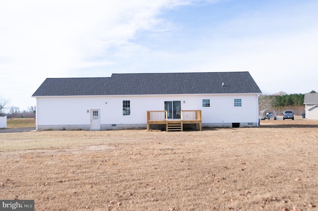 rear view of house featuring a wooden deck