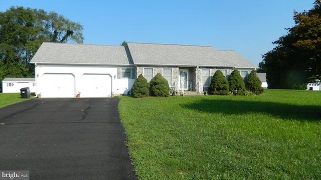 single story home featuring a front yard and a garage