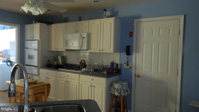 kitchen featuring backsplash, white appliances, sink, and ceiling fan