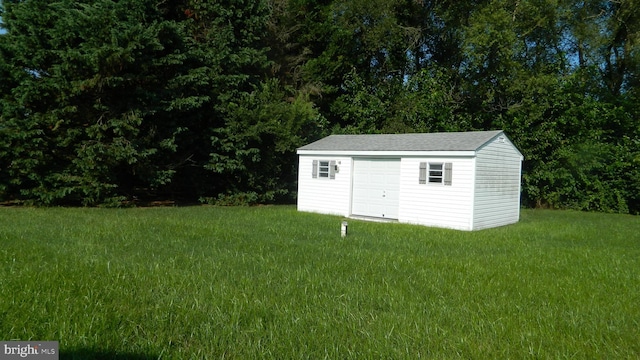 view of outbuilding featuring a yard