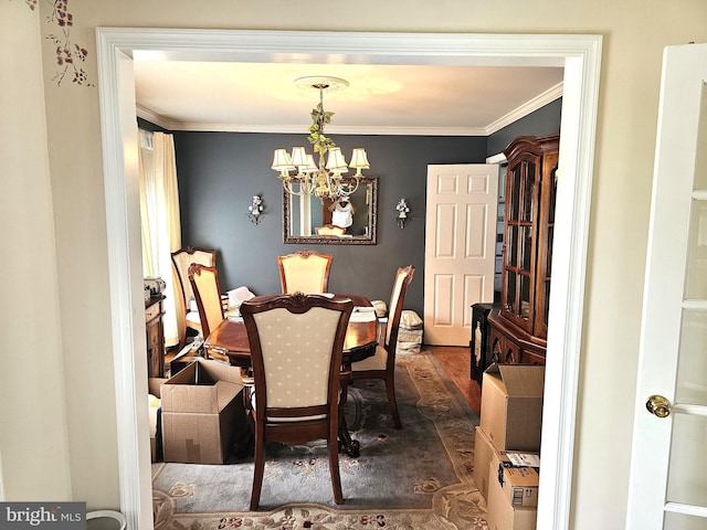 dining area featuring a chandelier, ornamental molding, and dark hardwood / wood-style flooring