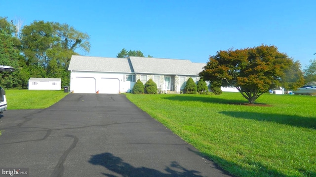 view of front of home featuring a garage and a front yard