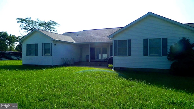 rear view of property with a yard