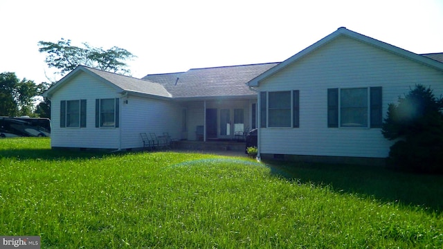 rear view of property with a lawn