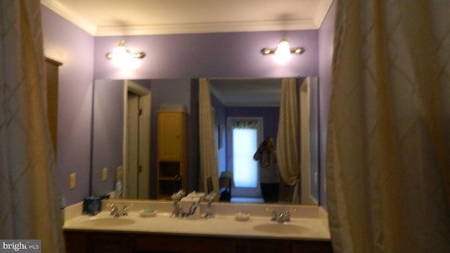 bathroom with ornamental molding and vanity