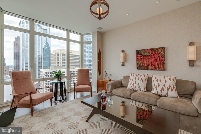 living room with wood-type flooring and expansive windows