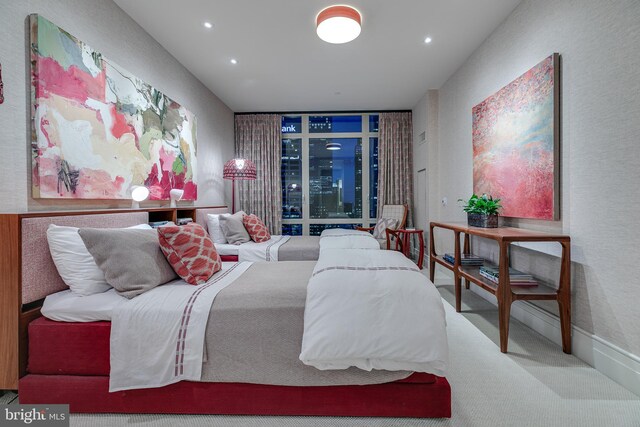 bedroom with a wall of windows and carpet