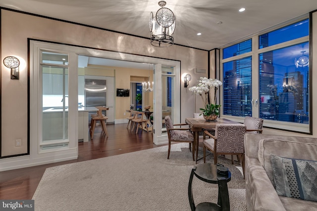 dining area featuring recessed lighting, dark wood-style flooring, a notable chandelier, and baseboards